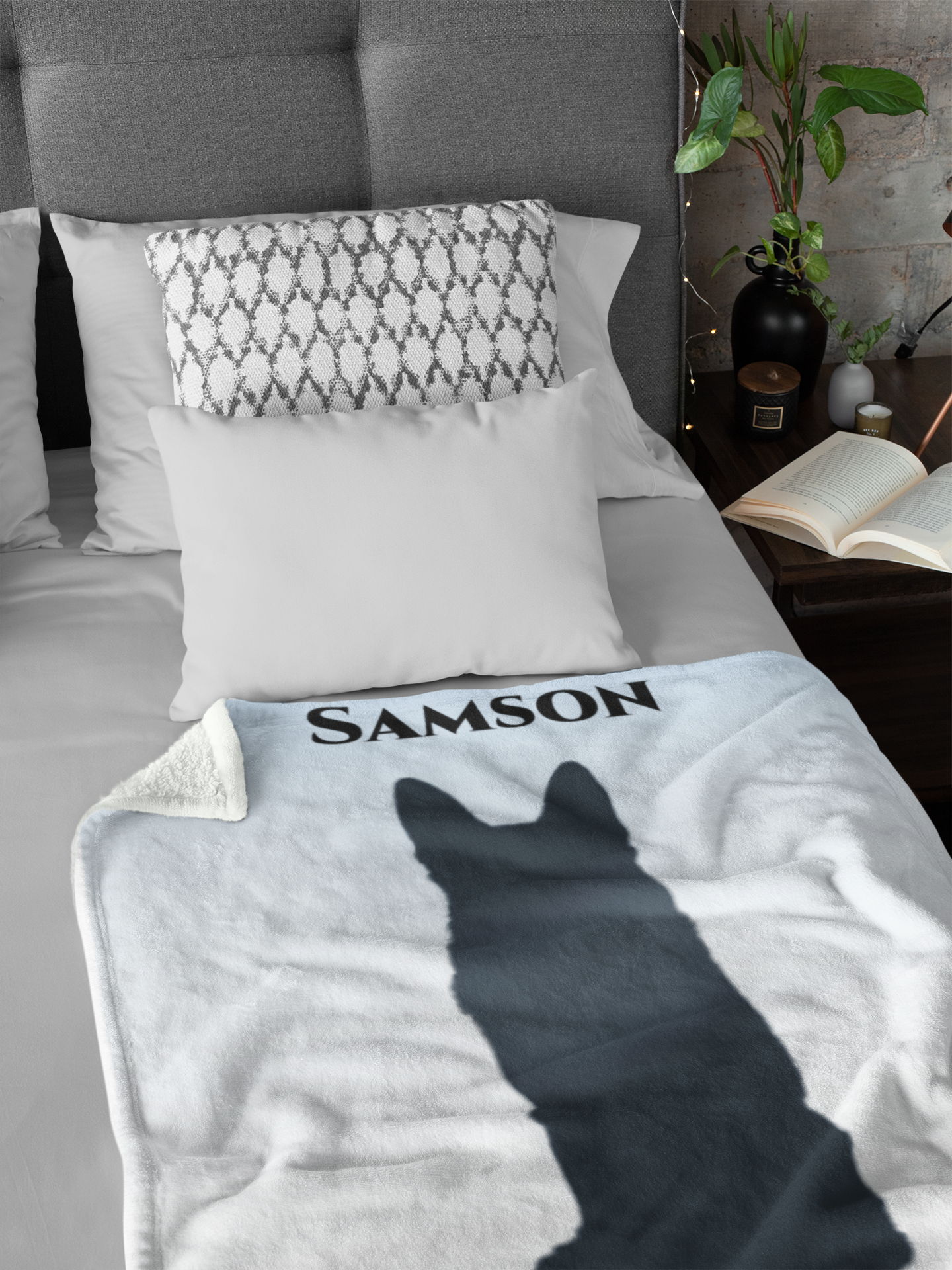 Custom pet remembrance blanket displayed on a bed, showing full silhouette artwork and memorial text.
