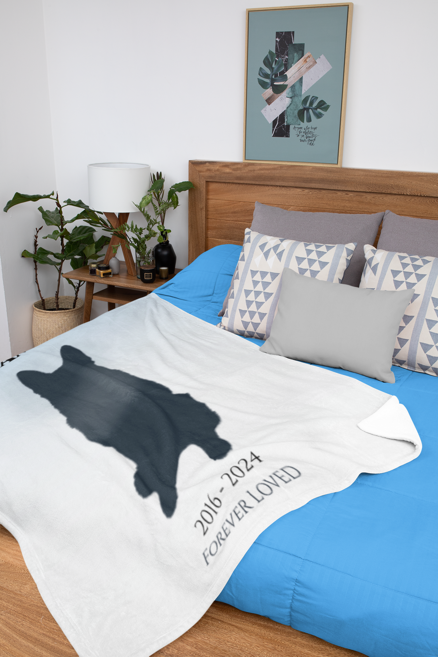 Soft velveteen pet memorial blanket folded on a bed, featuring custom name and dog silhouette design.
