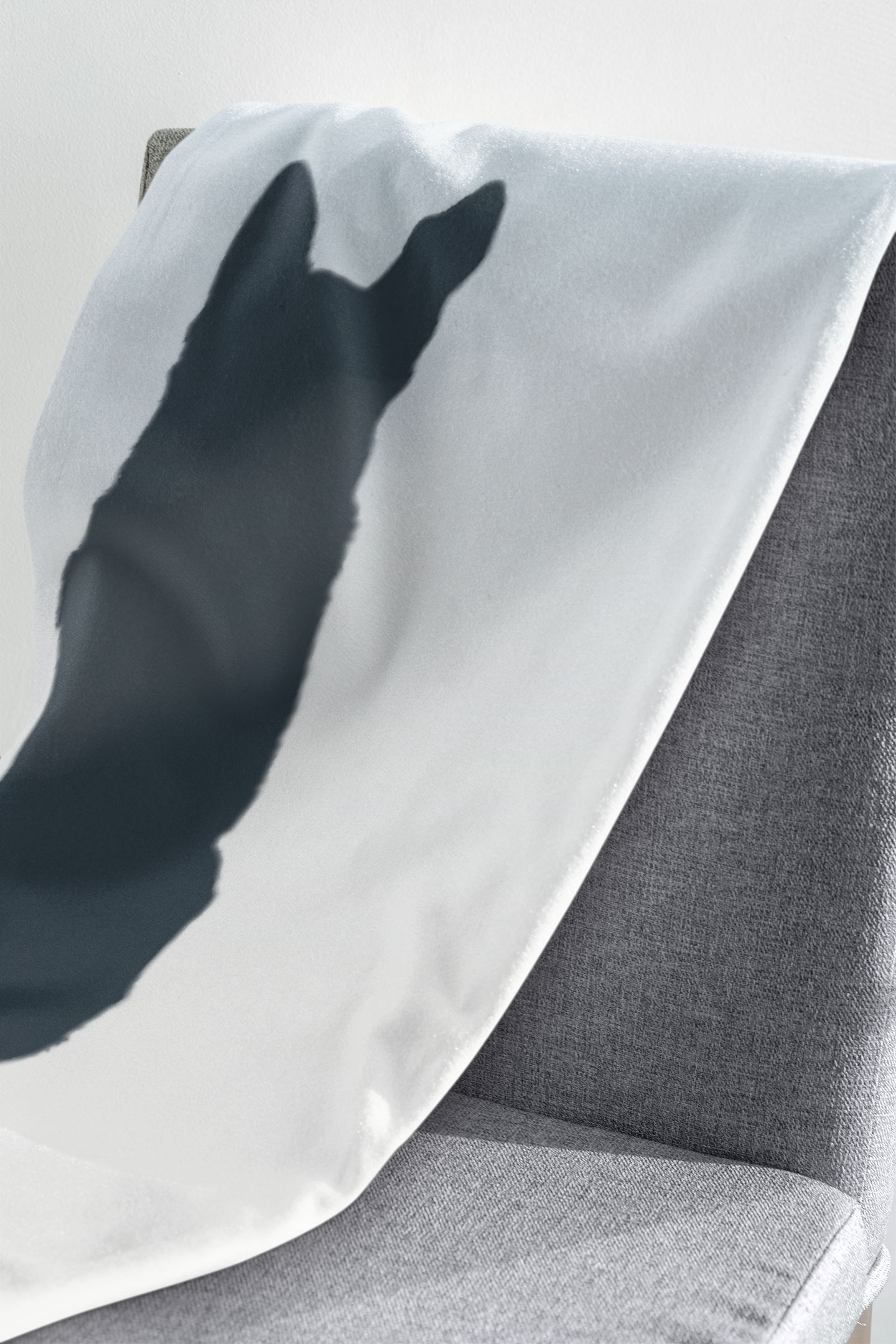 Close-up of personalized pet memorial blanket fabric showing watercolor gradient and silhouette details.
